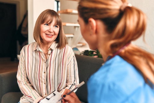 A lady being helped with some paperwork by a respite live-in carer.