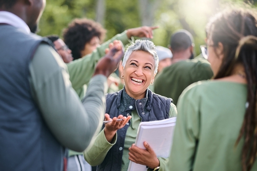 A women laughing whilst among a group of people