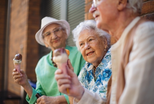 Three elderly people eating ice cream having respite care.