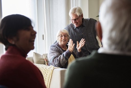 An elderly lady looking happy with a lve-in carer.