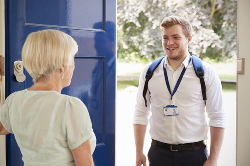 A care consultant at the front door of a house.