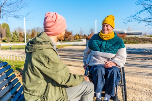 A spinal injury patinet being cared for ourside by a Conaultus live-in carer.