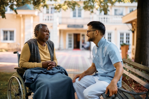 A lady who has had a stroke, sitting outside receiving live-in care.