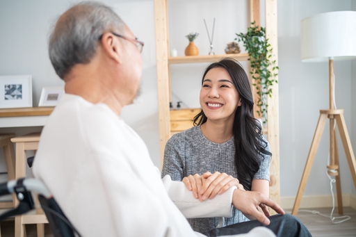 An elderly man with parkinsons being looked after by a live-in carer.