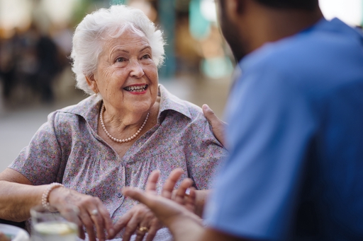 An elderly lady talking to a live-in nurse.