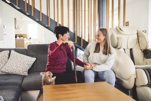 A woman with a walking stick talking to a live-in carer.
