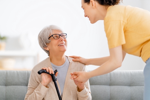 An elderly lady with motor neurone disease with her live-in carer.